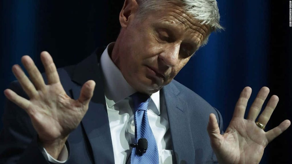 Gary Johnson candid political photo navy suit dark blue background expressive pose wallpaper