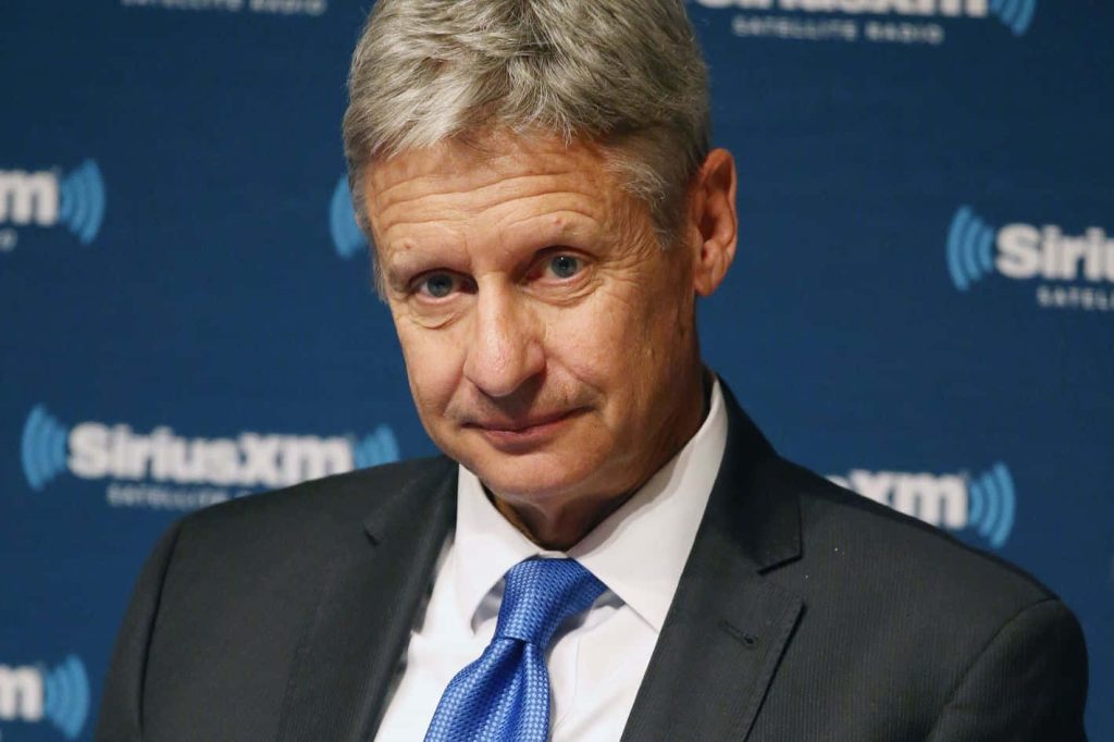 Professional headshot of Gary Johnson in suit and blue tie at SiriusXM media backdrop interview Wallpaper