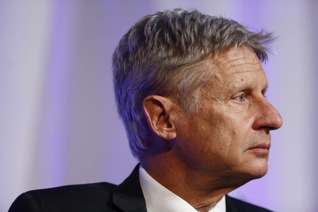 Gary Johnson professional portrait in formal suit looking sideways against purple background Wallpaper