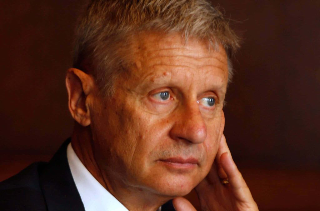Gary Johnson portrait thoughtful gaze dark background warm lighting professional wallpaper