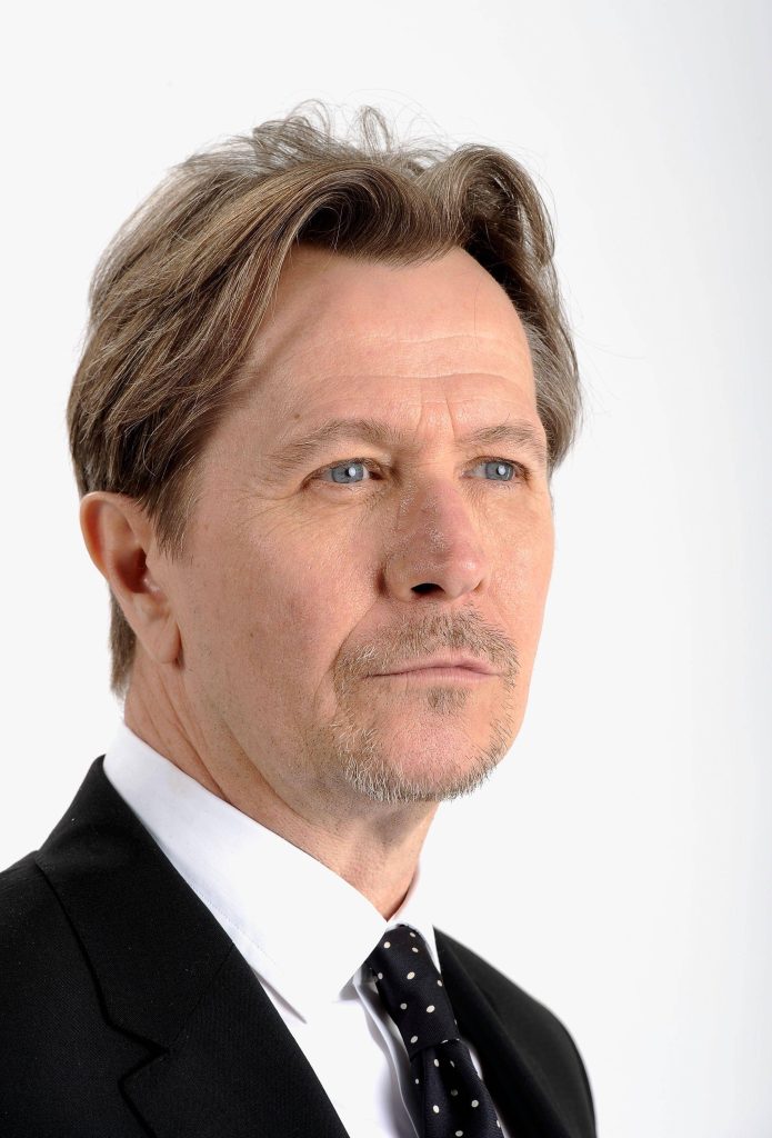 Gary Oldman professional studio portrait black suit white shirt polka dot tie white background Wallpaper