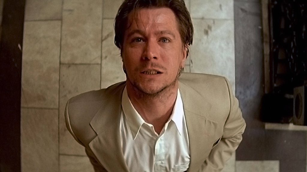 Gary Oldman as Norman Stansfield in beige suit intense gaze cinematic Léon The Professional wallpaper