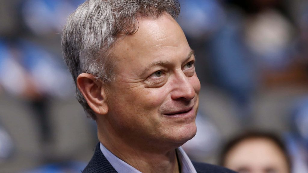 Gary Sinise close-up portrait smiling warm lighting professional desktop wallpaper background
