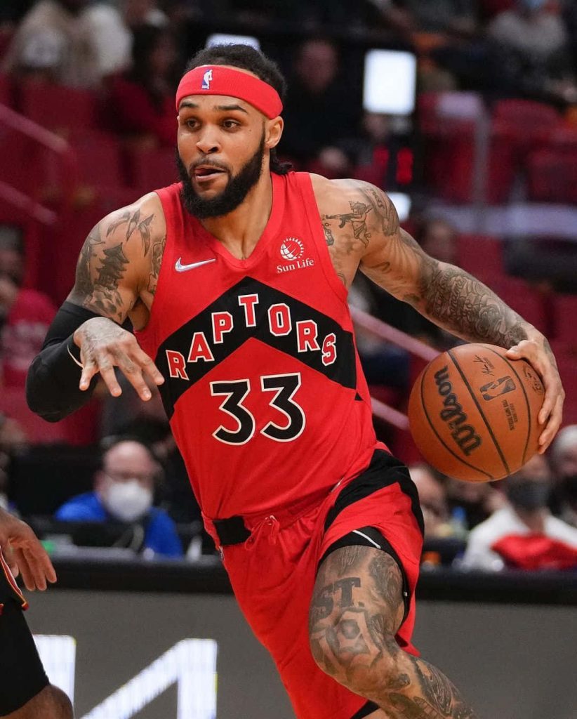 Gary Trent Jr NBA action wallpaper Toronto Raptors red jersey dribbling basketball intense focus