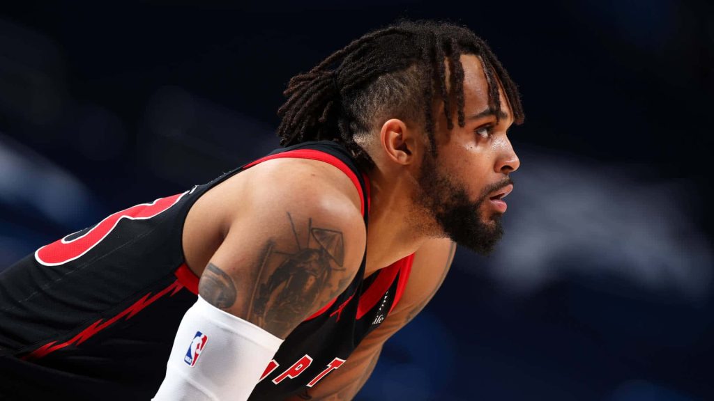 Gary Trent Jr focused in black Raptors jersey detailed arm tattoo basketball arena background Wallpaper