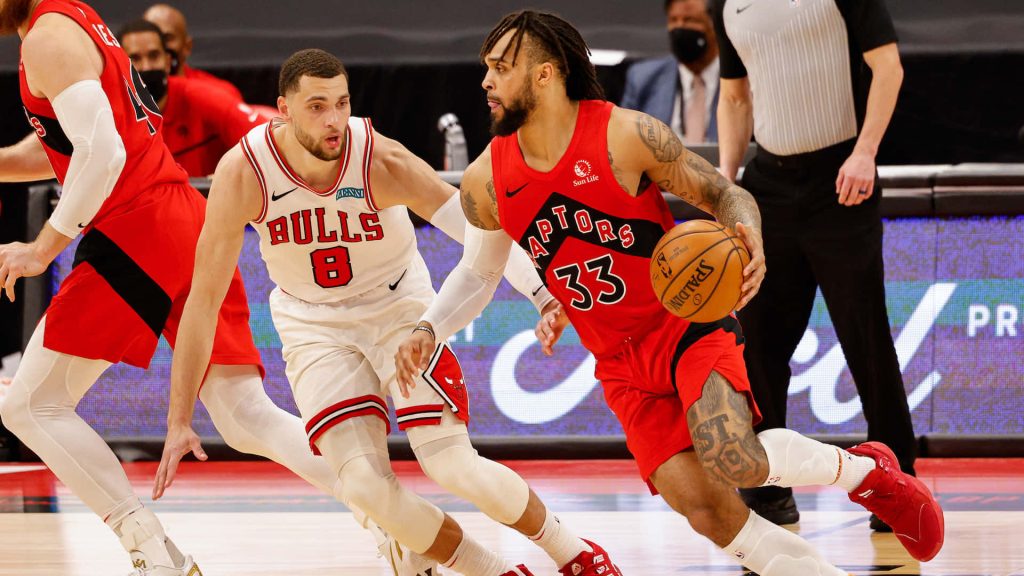 Gary Trent Jr driving past Zach LaVine intense NBA action Raptors vs Bulls basketball wallpaper