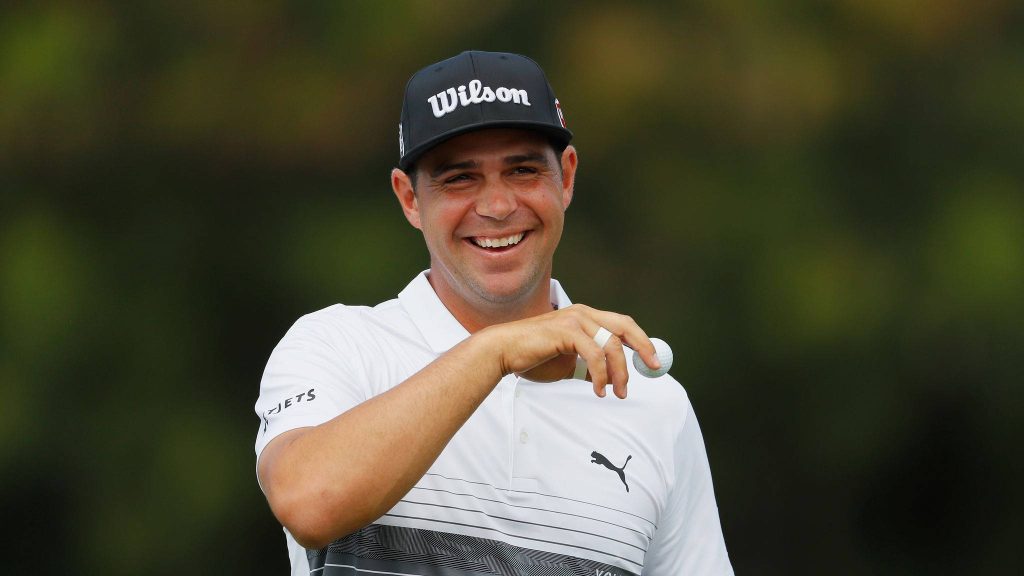 Professional golfer Gary Woodland laughing in white Puma polo and black Wilson cap golf wallpaper