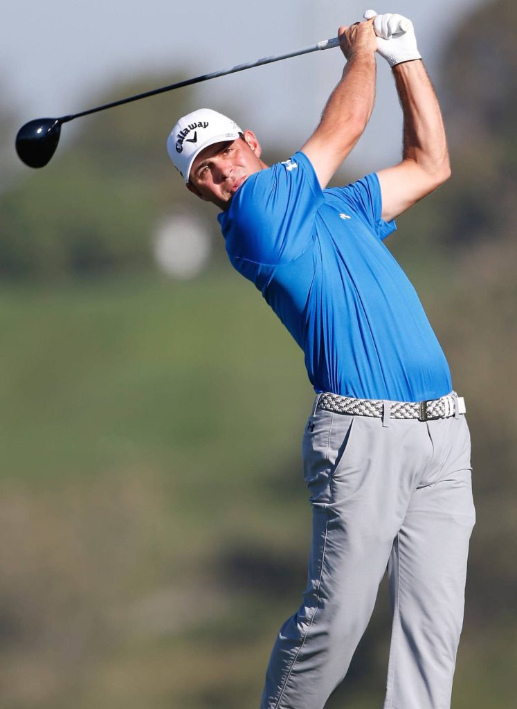 Gary Woodland mid-swing phone wallpaper vibrant blue polo green background high resolution