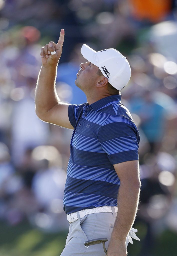 Gary Woodland celebrating victory in blue Under Armour polo on sunlit golf course wallpaper