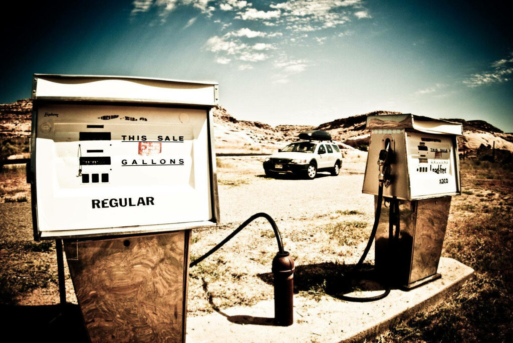 Vintage Gas Station: Vignette-Filtered Snapshot Showcasing Striking Blue Sky Backdrop Wallpaper