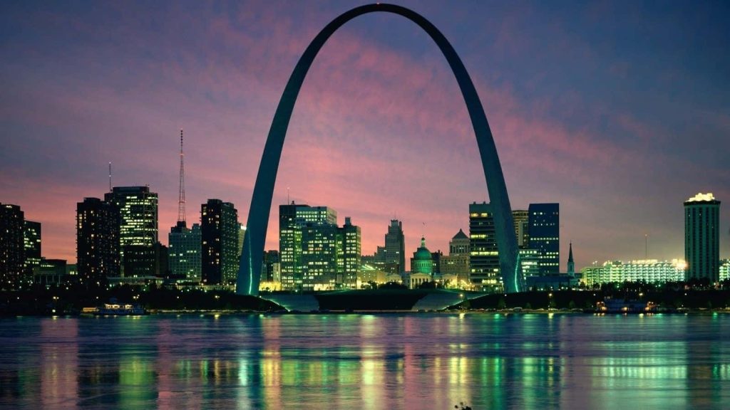 Gateway Arch National Park silhouette at twilight with vibrant St Louis skyline reflections on river Wallpaper