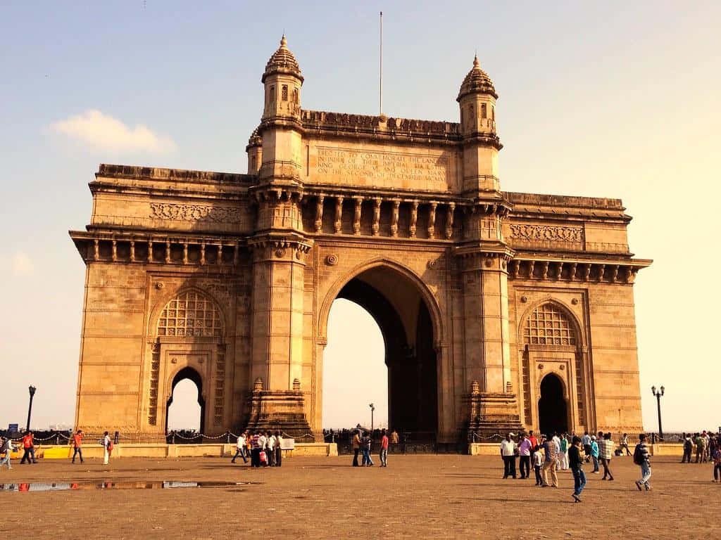 Gateway of India Mumbai golden hour archway with intricate stonework and busy plaza background Wallpaper