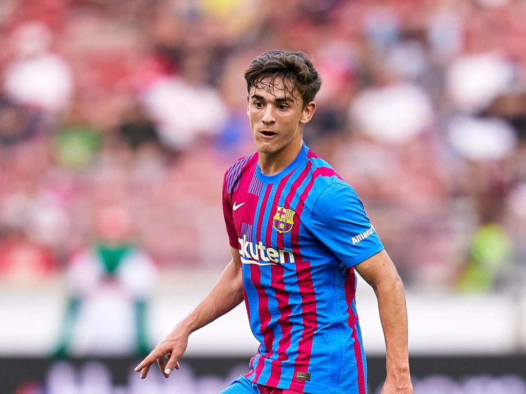 Gavi FC Barcelona midfielder intense focus action shot blue and red home kit wallpaper background