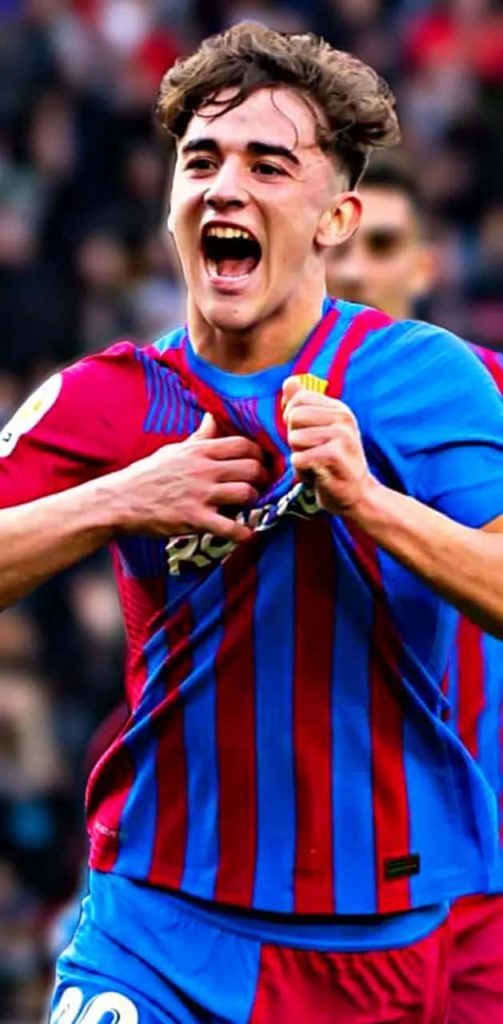Gavi FC Barcelona celebrating goal in blue red jersey dynamic football action wallpaper background