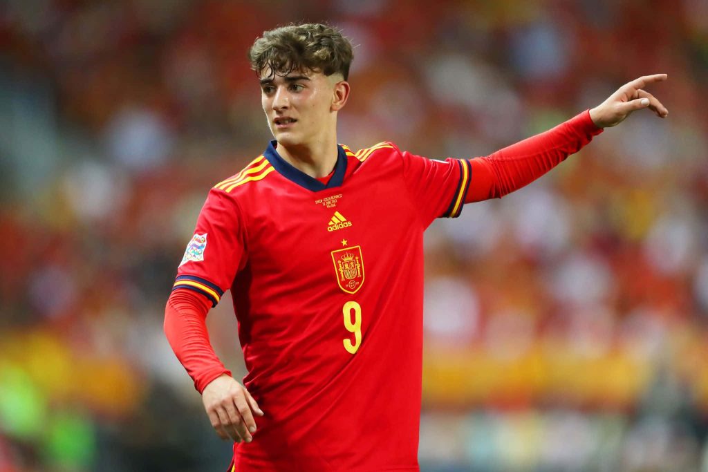Gavi Spain footballer in red jersey number 9 action shot vibrant stadium wallpaper background