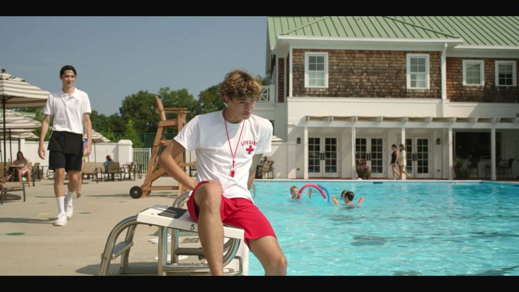 Gavin Casalegno poolside in lifeguard tee and red shorts summer outdoor starting block wallpaper