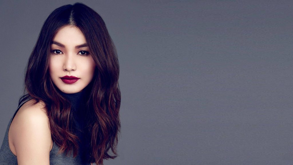 Gemma Chan professional portrait with long waves berry lipstick grey minimalist studio background Wallpaper
