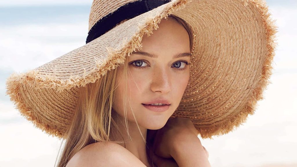 Supermodel Gemma Ward wearing straw hat glowing in natural light serene summer fashion portrait Wallpaper
