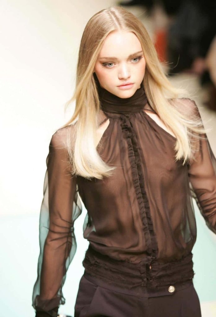 Australian supermodel Gemma Ward in sheer brown ruffled blouse on runway high fashion wallpaper
