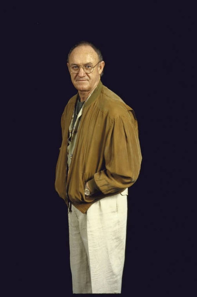 Classic portrait of Gene Hackman in tan bomber jacket black background high-quality wallpaper