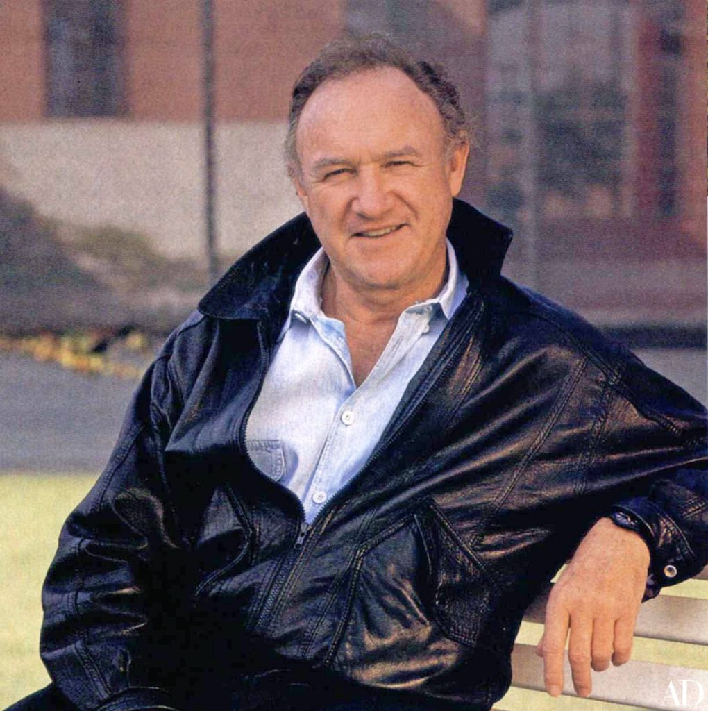 Gene Hackman classic portrait outdoors wearing black leather jacket on bench with soft background Wallpaper