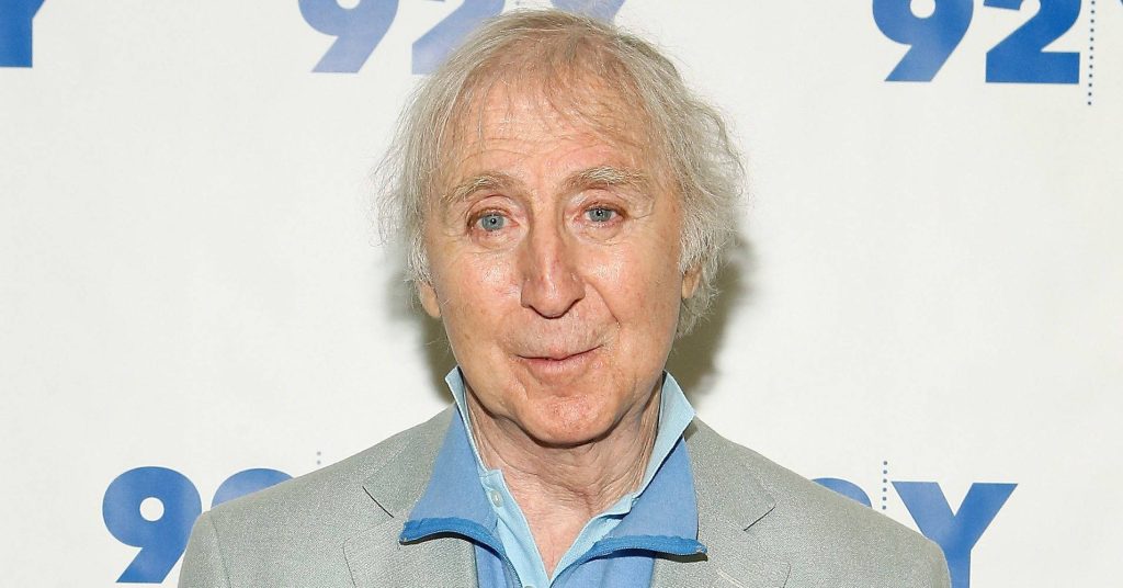 Gene Wilder portrait wallpaper in blue shirt grey blazer against 92Y backdrop professional photo