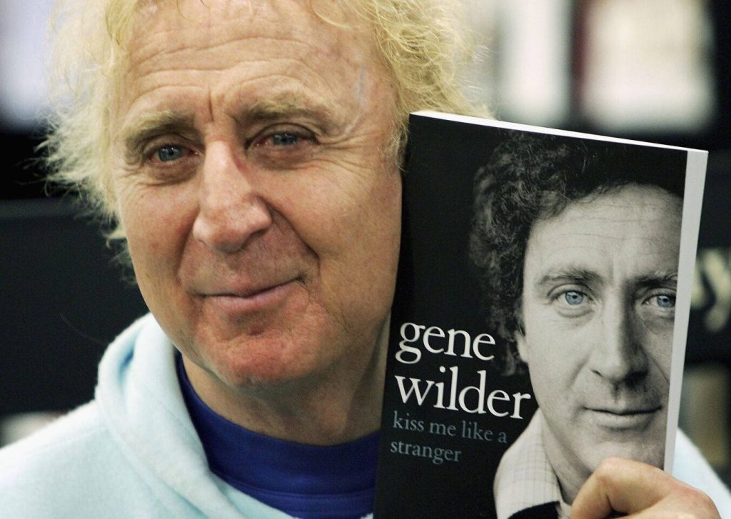 Gene Wilder smiling with curly hair holding Kiss Me Like a Stranger book portrait wallpaper