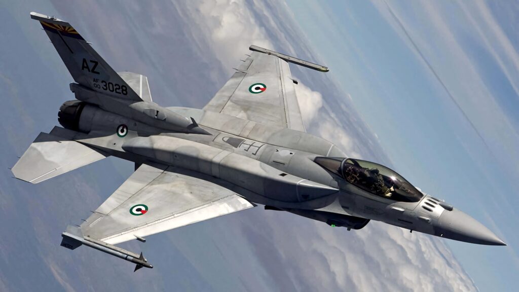 General Dynamics F-16 Fighting Falcon jet soaring above clouds with sleek gray fuselage and markings Wallpaper