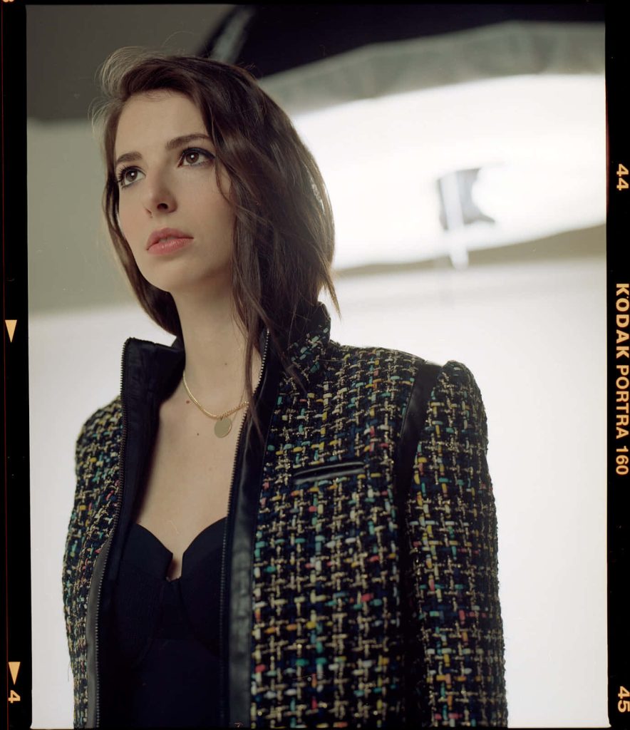 Actress Genevieve Buechner in multi-colored tweed jacket leather trim gold necklace studio portrait Wallpaper