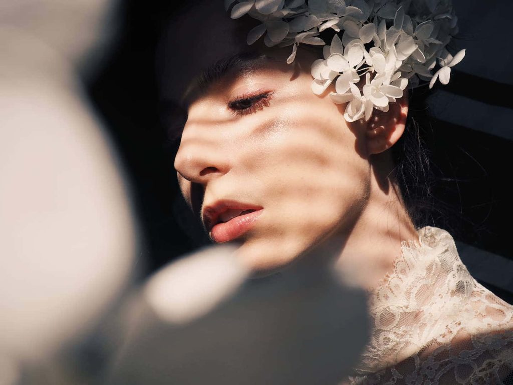 Genevieve Buechner portrait with dramatic striped shadows white floral headpiece lace dress Wallpaper
