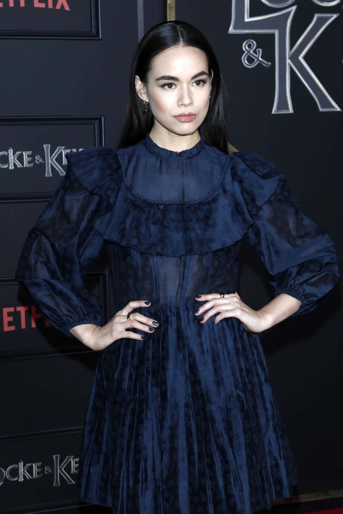 Actress Genevieve Kang in navy blue ruffled dress at Locke & Key Netflix premiere red carpet event Wallpaper