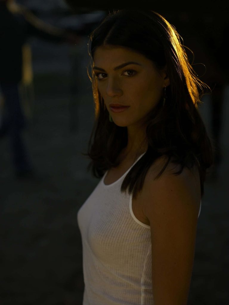 Actress Genevieve Padalecki in white tank top with dramatic golden backlight portrait wallpaper