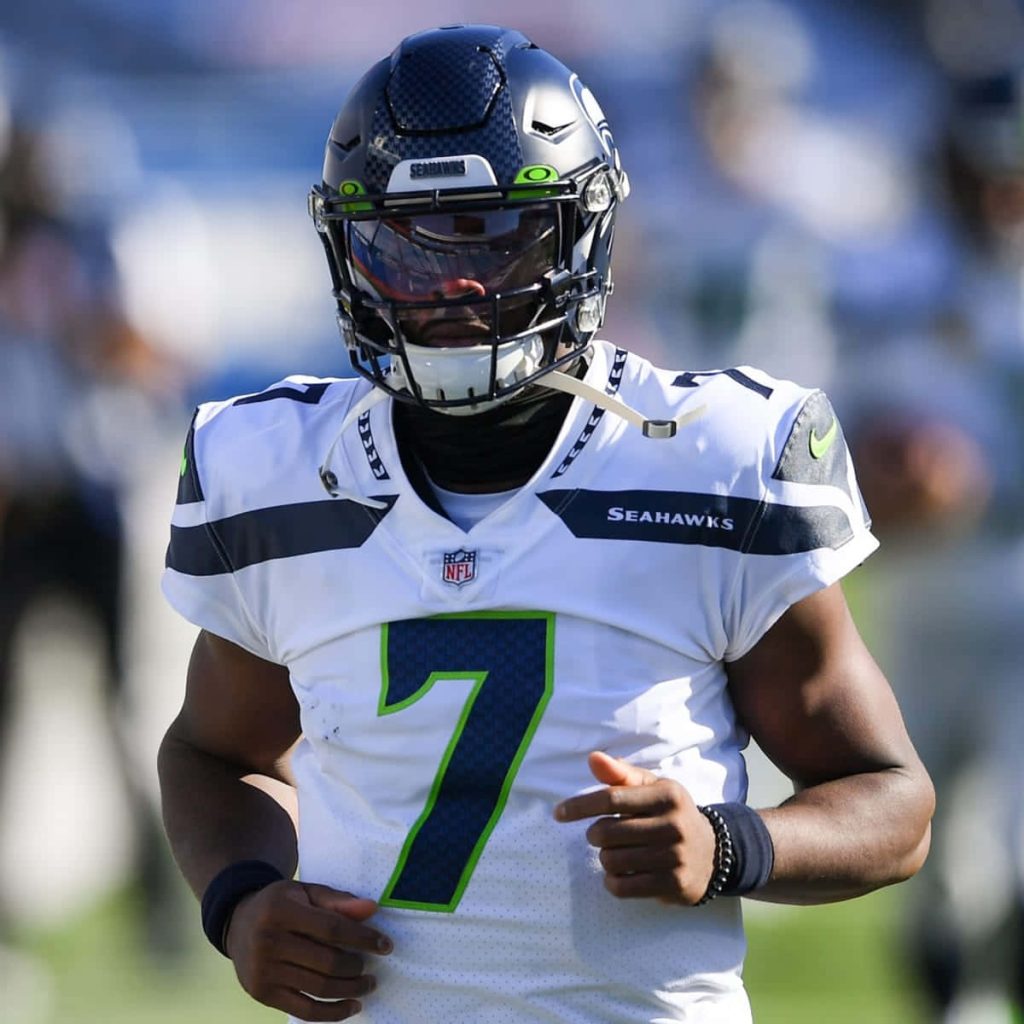 Seattle Seahawks quarterback Geno Smith in white jersey and helmet intense action wallpaper