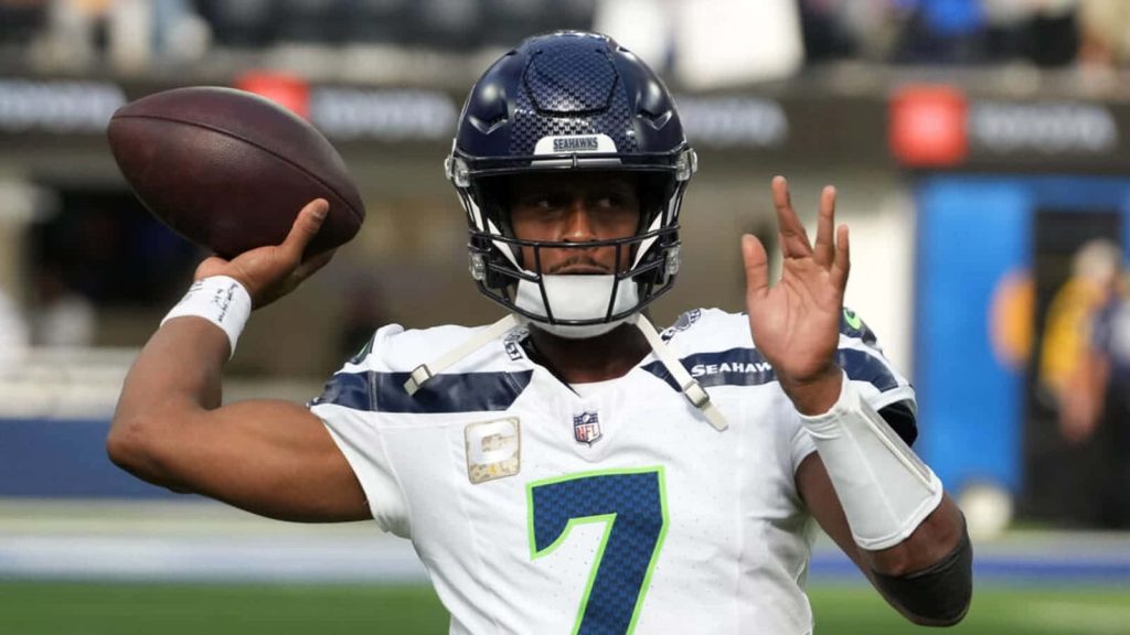 Seattle Seahawks quarterback Geno Smith in white jersey preparing to throw NFL game pass wallpaper