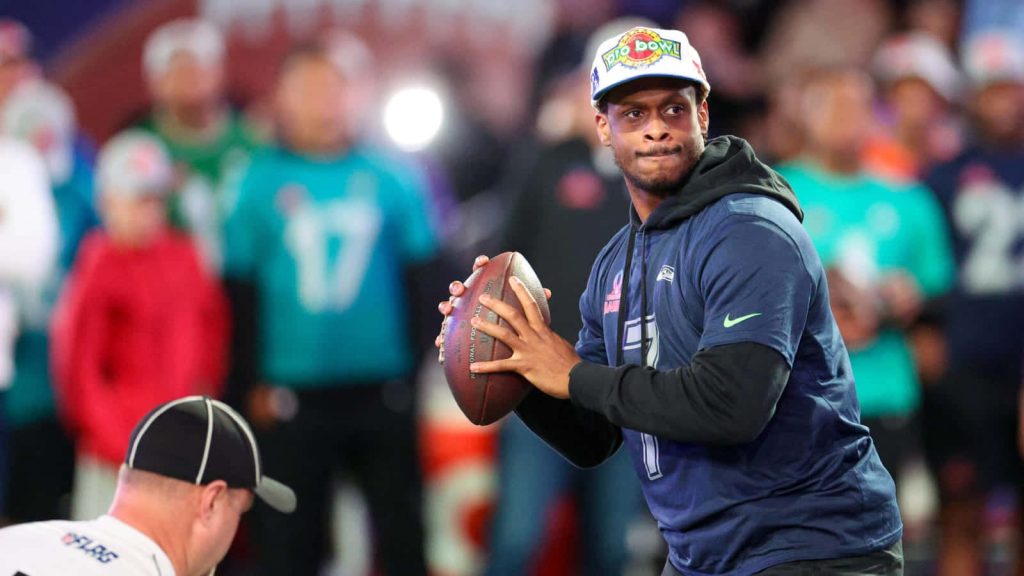 Seattle Seahawks quarterback Geno Smith in Pro Bowl jersey ready to pass in stadium lighting Wallpaper