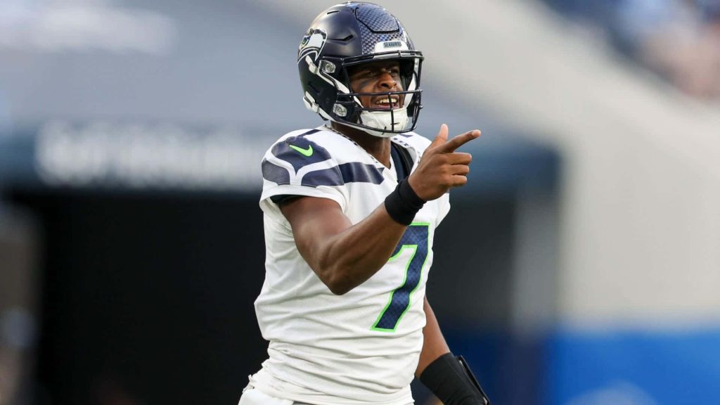 Geno Smith Seattle Seahawks quarterback smiling in white jersey pointing on the field wallpaper