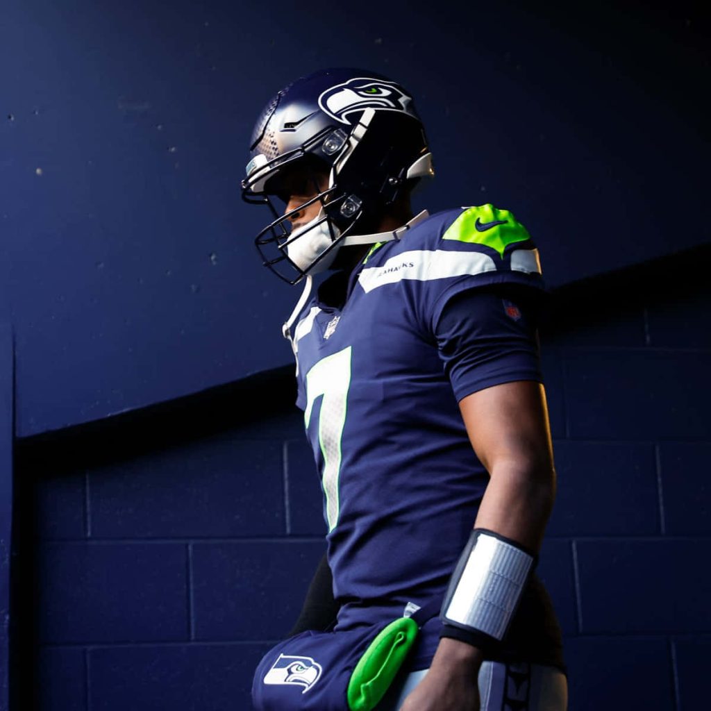 Seattle Seahawks quarterback Geno Smith in navy jersey seven in dramatic tunnel lighting wallpaper