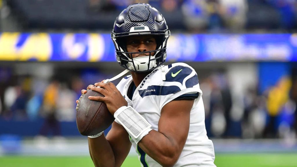 Seattle Seahawks quarterback Geno Smith in white jersey preparing to throw NFL action wallpaper