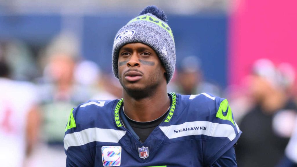 Seattle Seahawks quarterback Geno Smith in jersey and beanie with focused game-day look Wallpaper