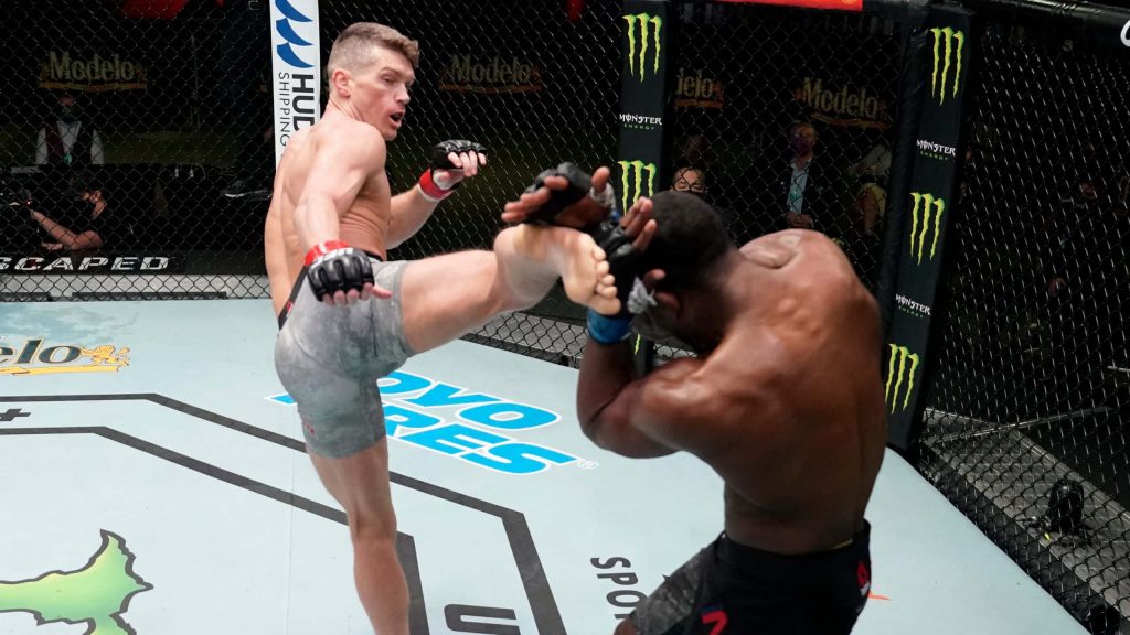 UFC fight action Geoff Neal blocks high head kick from Stephen Wonderboy Thompson in octagon Wallpaper