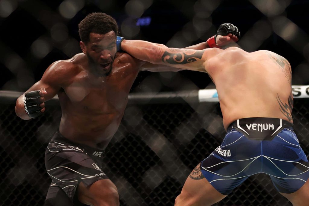 MMA fighter Geoff Neal dodges strike from Santiago Ponzinibbio in intense UFC fight action Wallpaper