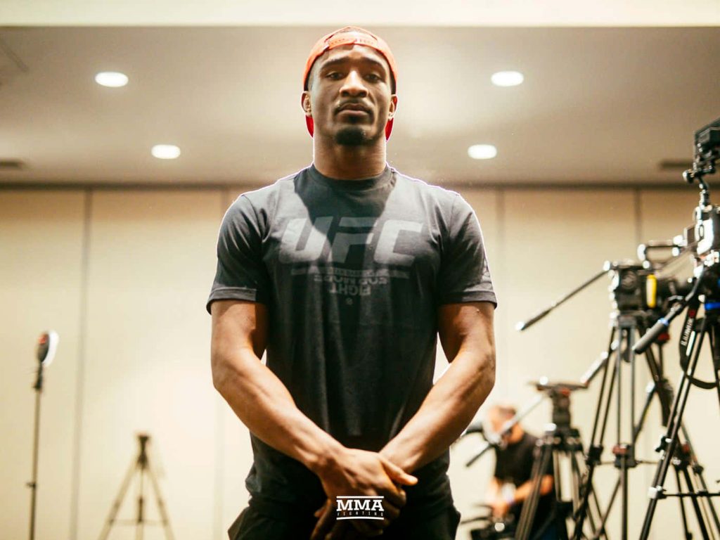 Geoff Neal UFC fighter in orange cap dark shirt media session high-quality MMA wallpaper background