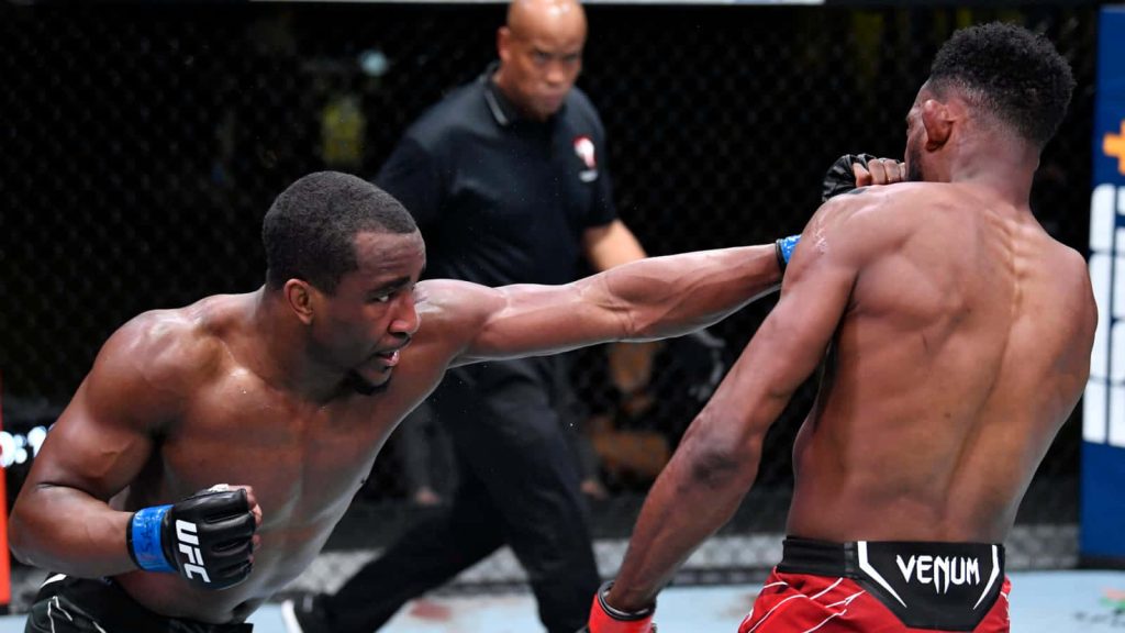 UFC Geoff Neal lands powerful right cross in intense MMA fight with vibrant arena lighting wallpaper