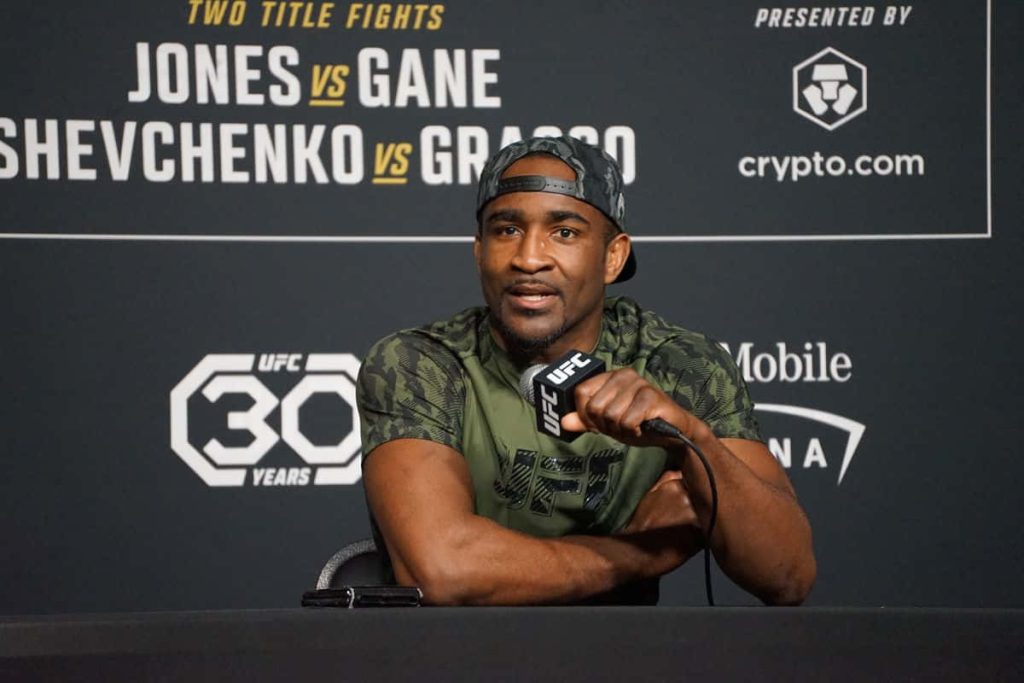 UFC welterweight Geoff Neal in camo t-shirt and cap at UFC 30 Years Jones vs Gane press conference Wallpaper