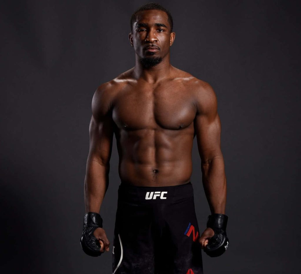 Geoff Neal UFC fighter shirtless portrait in black gloves dramatic shadowed studio background Wallpaper