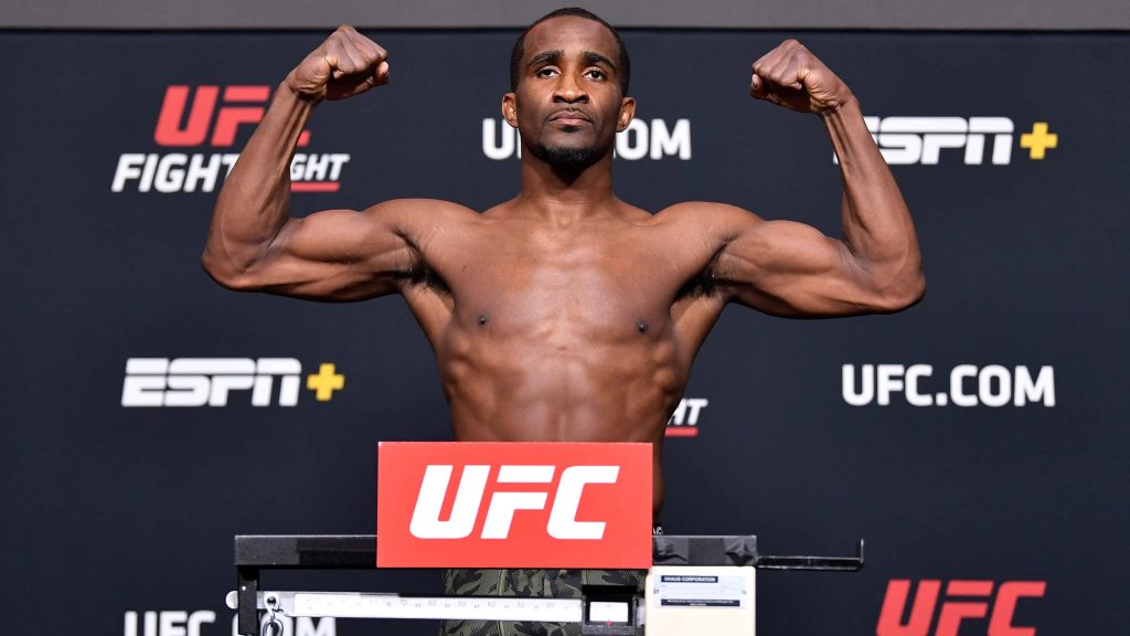 UFC fighter Geoff Neal flexing muscles at official weigh-in black red UFC backdrop wallpaper