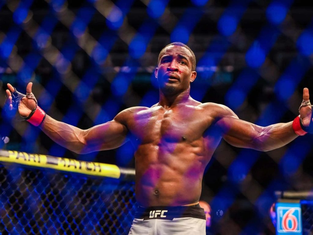 Geoff Neal UFC welterweight fighter celebrating in Octagon with dramatic cage arena lighting Wallpaper
