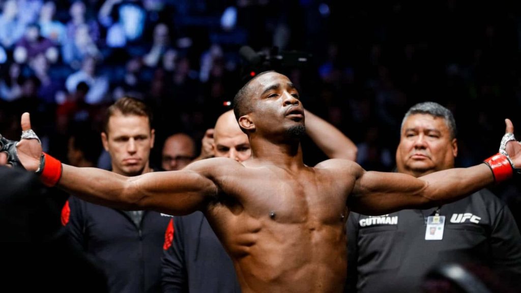 UFC welterweight Geoff Neal triumphant pose in arena with corner team MMA sports wallpaper background