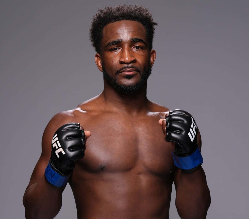 Geoff Neal UFC professional portrait in fighting stance with black MMA gloves gray background wallpaper