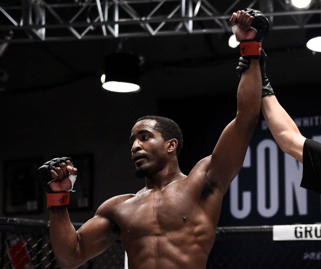 Geoff Neal MMA fighter celebrating victory with raised arm in intense arena lighting wallpaper